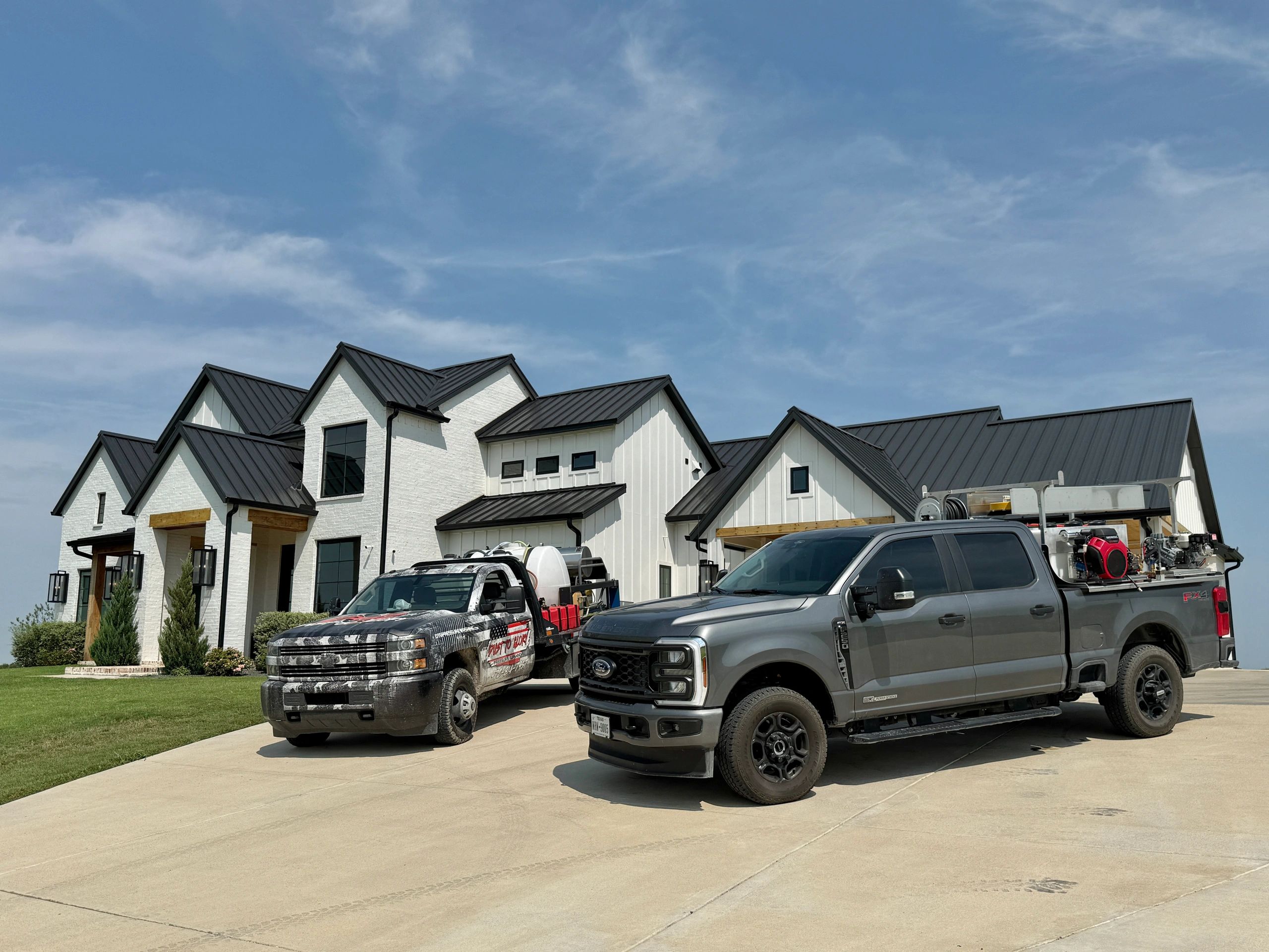 Dust To Glory work trucks at a residential property